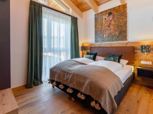 a bedroom with a large bed with a large window at Chalet Kolibri in Sankt Lambrecht