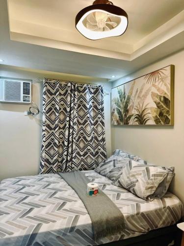 a bedroom with a bed and a ceiling with a fan at 2 Bedroom Elegant Condo Cebu in Mandaue City
