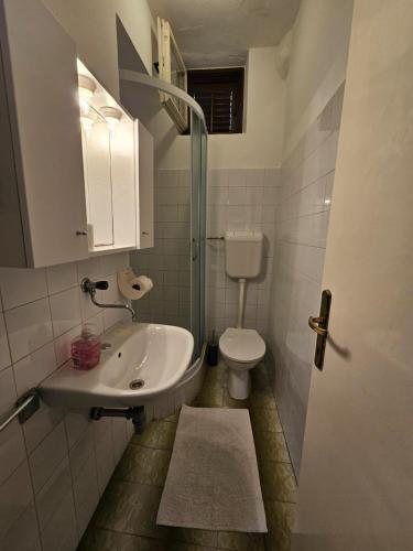 a bathroom with a sink and a toilet at Apartment Savar 8079a in Brbinj