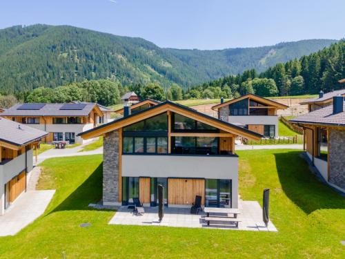 an aerial view of a house with mountains in the background at Grebenzen Top Chalet Mazzel in Sankt Lambrecht