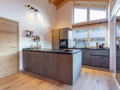 a large kitchen with a large island in a room at Grebenzen Lodge Hirsch in Sankt Lambrecht