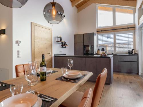 a dining room with a table with wine glasses at Grebenzen Lodge Hirsch in Sankt Lambrecht