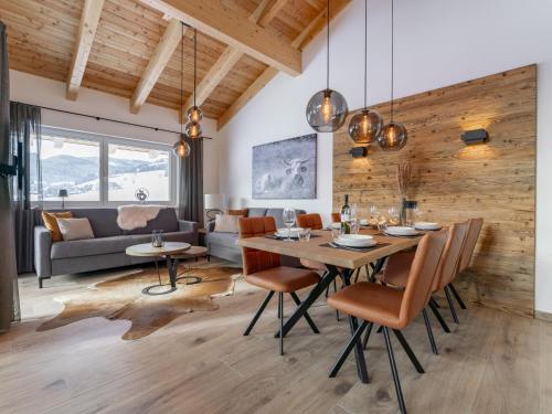 a dining room and living room with a table and chairs at Grebenzen Lodge Hirsch in Sankt Lambrecht