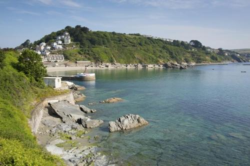 a view of a body of water with a mountain at The Gulls in Looe