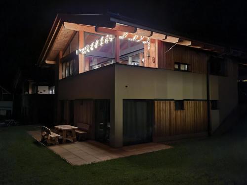 a building with a bench in front of it at night at Grebenzen Lodge Prinz in Sankt Lambrecht