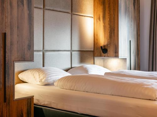 a bedroom with two beds with a headboard at Grebenzen Lodge 35 in Sankt Lambrecht