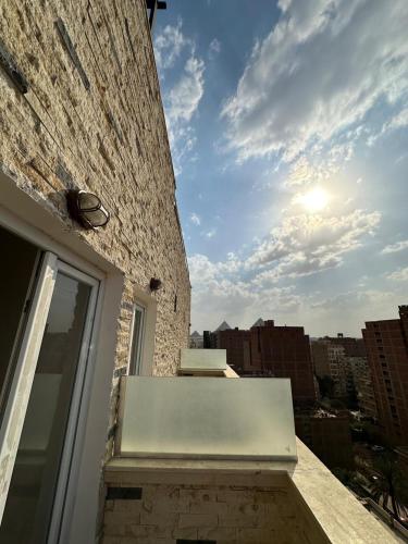 a window on a building with the sky in the background at king pyramids in Cairo