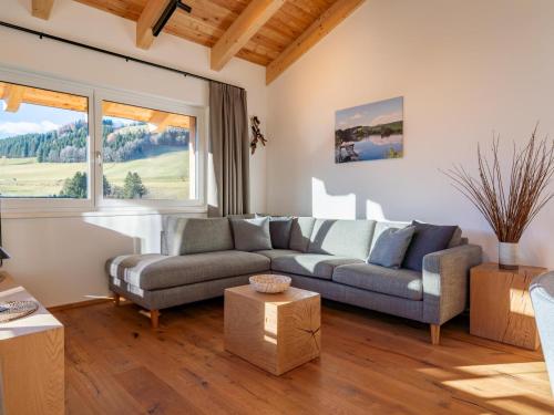 a living room with a couch and a large window at Grebenzen Eiszeit Lodge in Sankt Lambrecht