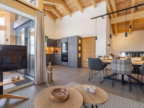 a living room with a table and chairs and a television at Alpenchalet Lambert in Sankt Lambrecht