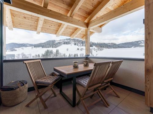 a table and two chairs on a balcony with a view at Alpenchalet Lambert in Sankt Lambrecht