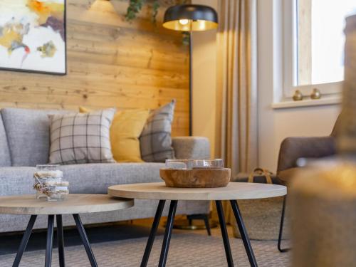 a living room with a couch and two tables at Alpenchalet Lambert in Sankt Lambrecht