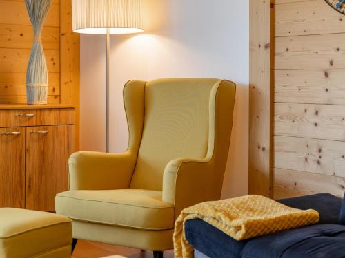 a yellow chair sitting next to a lamp in a room at Pabstin in Sankt Lambrecht