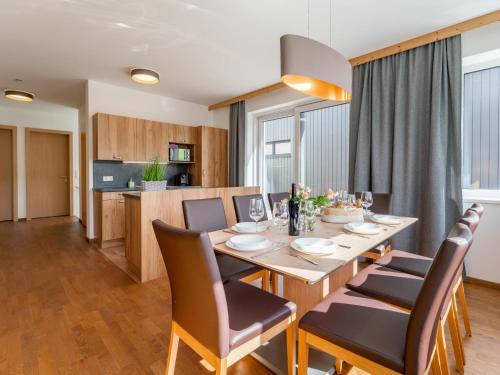 a dining room and kitchen with a table and chairs at Pabstin in Sankt Lambrecht