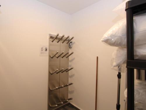 a kitchen with a refrigerator with hangers on the wall at Grebenzen Lodge 53 in Sankt Lambrecht