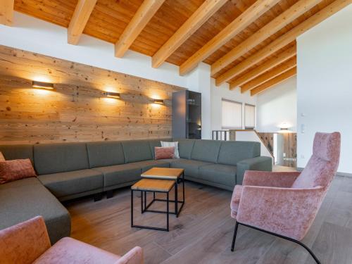 a living room with a couch and chairs and a table at Grebenzen Lodge 53 in Sankt Lambrecht