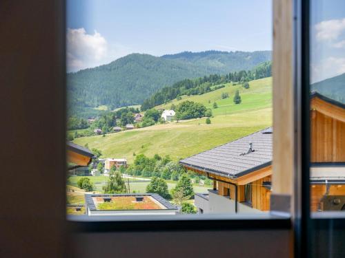 a view of a mountain from a window at Grebenzen Lodge 53 in Sankt Lambrecht