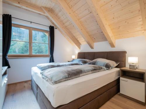 a bedroom with a large bed and a window at Ebersberger in Donnersbachwald