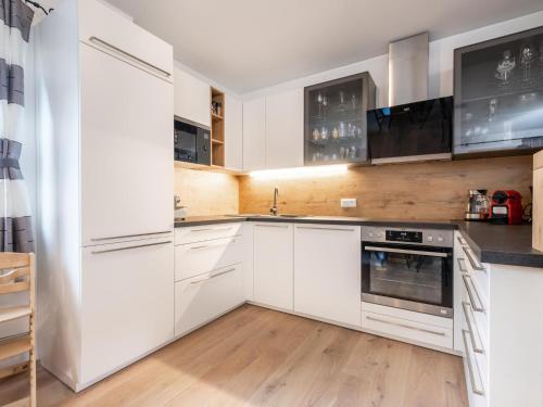 a white kitchen with white cabinets and appliances at Ebersberger in Donnersbachwald