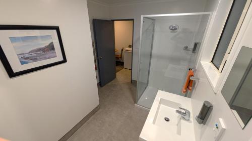 a bathroom with a sink and a shower at The Peninsula Kaikoura in Kaikoura