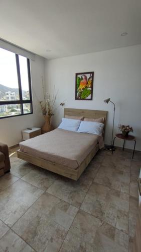 a bedroom with a large bed in a room at Vita905 RODADERO in Santa Marta