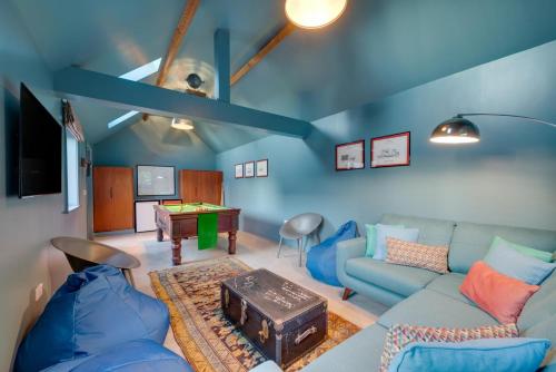 a living room with a couch and a table at The Barn at The Foldyard in Holme upon Spalding Moor