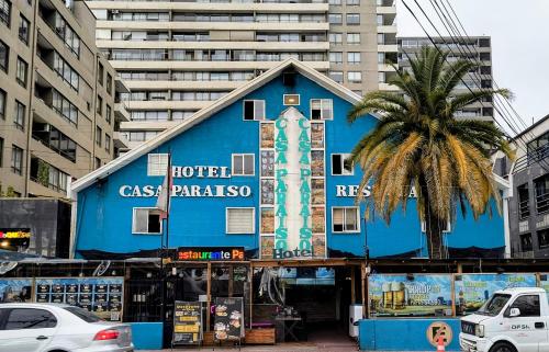 a blue building in the middle of a city at Casa Paraiso Hotel in Santiago
