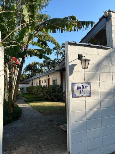 a no man sign on a white garage door at Ao Mar - Hospedagem in São Sebastião