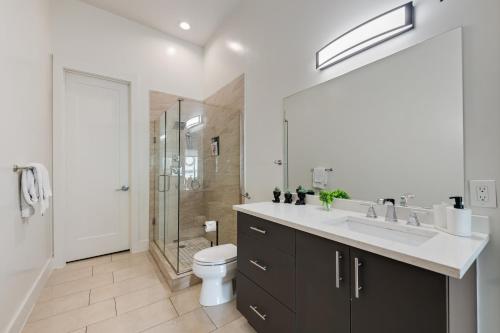 a bathroom with a toilet and a sink and a shower at City View 1BR I Gym I Free Parking I Workspace in Dallas