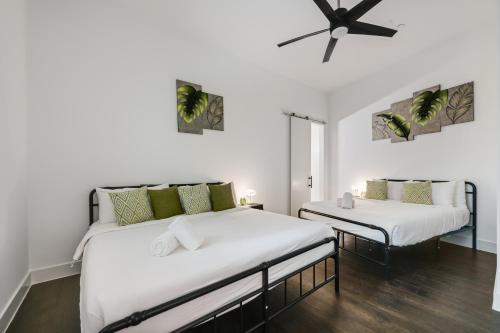 two beds in a room with white walls at City View 1BR I Gym I Free Parking I Workspace in Dallas