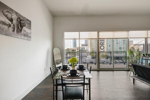 a dining room with a table and chairs and windows at City View 1BR I Gym I Free Parking I Workspace in Dallas