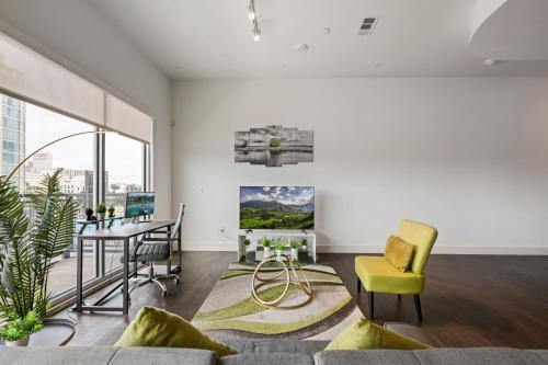 a living room with a couch and a table and chairs at City View 1BR I Gym I Free Parking I Workspace in Dallas