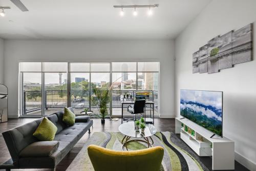 a living room with a couch and a tv at City View 1BR I Gym I Free Parking I Workspace in Dallas