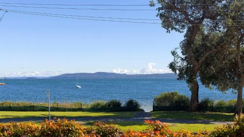 a view of the water with a boat in the distance at Mariners One 1 at 39 Victoria Parade in Nelson Bay