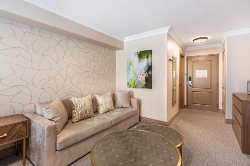a living room with a couch and a table at Velora Hinton, an Ascend Collection Hotel in Hinton