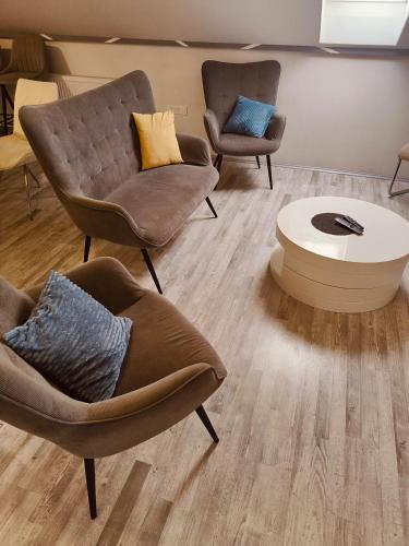 a living room with two chairs and a coffee table at BL App in Antunovac