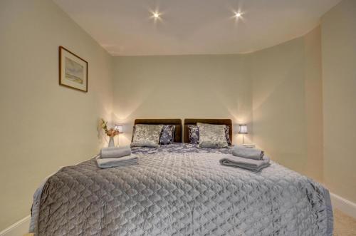 a bedroom with a large bed with two pillows at Mariners in Barbrook
