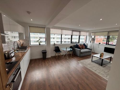 a kitchen and living room with a couch and a table at Carlton Square Luxury Apartments in Nottingham