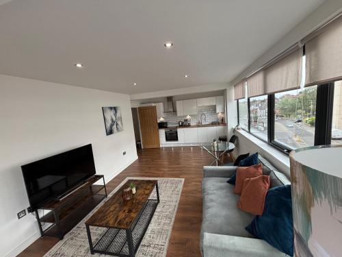 a living room with a couch and a table at Carlton Square Luxury Apartments in Nottingham