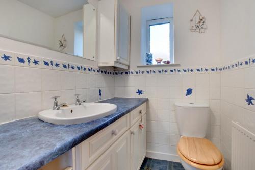 a bathroom with a sink and a toilet at Cherry Garth in Sleights