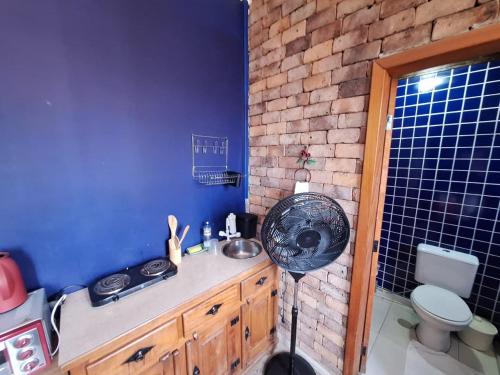 a bathroom with a sink and a fan in it at Lindo flat Caxambu Vila Rica Pampulha in Venda Nova