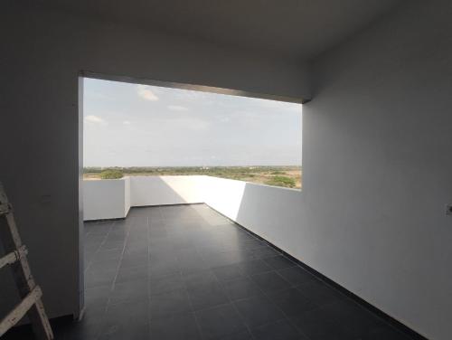 a room with a large window and a tile floor at casa mara dakar in Bargny