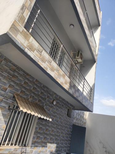 an external view of a building with a balcony at casa mara dakar in Bargny