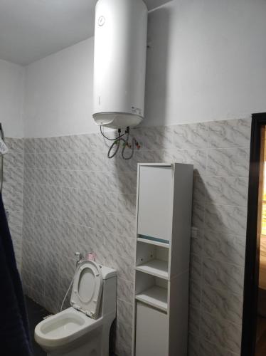 a small bathroom with a toilet and a sink at casa mara dakar in Bargny