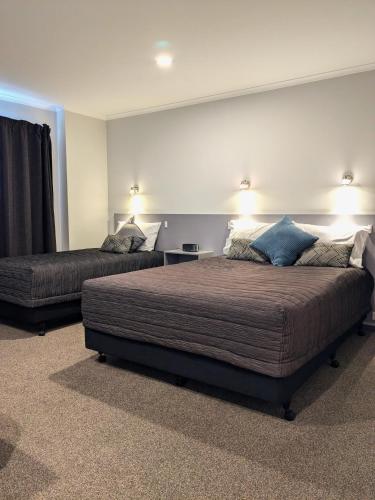 a bedroom with a large bed and a couch at The Peninsula Kaikoura in Kaikoura