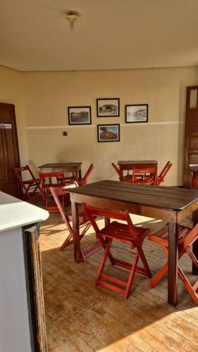 a group of tables and chairs in a room at Hotel Brasil in Piquete