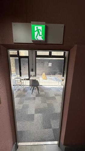 an exit door to a building with a sign on it at 心斎橋難波南Ambers hotel 3322 in Osaka
