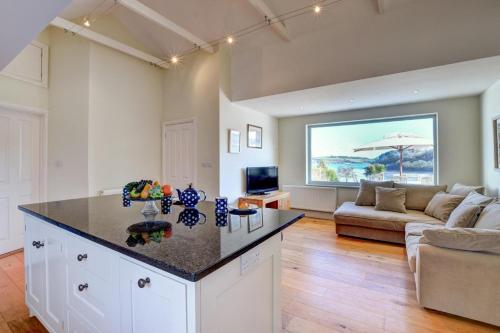 a kitchen and living room with a large window at Lithuanica in Helford