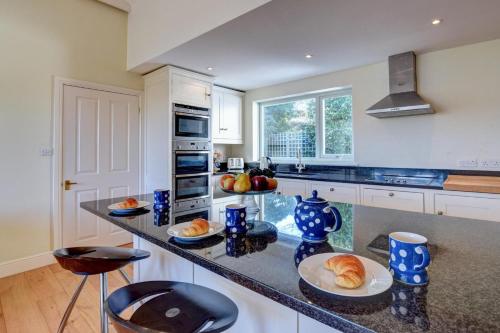 a kitchen with a counter with plates of food on it at Lithuanica in Helford