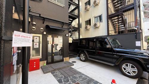 a black truck parked in front of a building at 心斎橋難波南Ambers hotel 3322 in Osaka