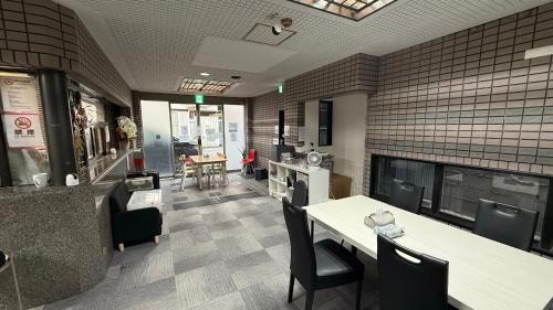a restaurant with a table and chairs and a kitchen at 心斎橋難波南Ambers hotel 3322 in Osaka